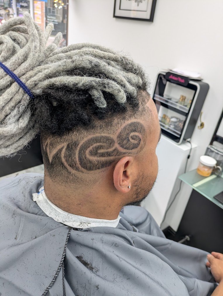 Detailed hair design with faded sides at 1st Class Fades