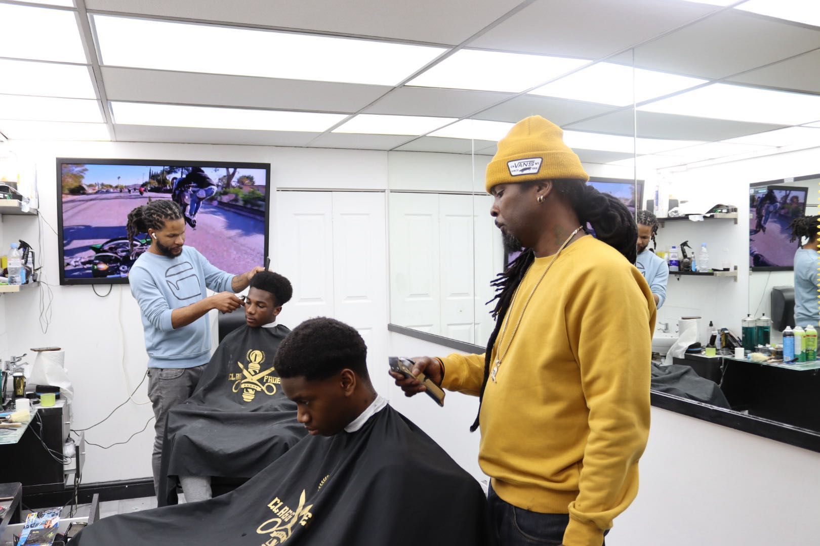 Barbers cutting hair inside 1st Class Fades